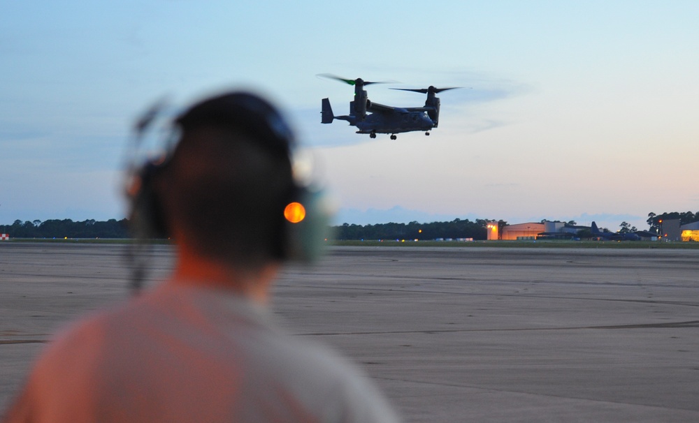 Crew chiefs guide in a CV-22B Osprey