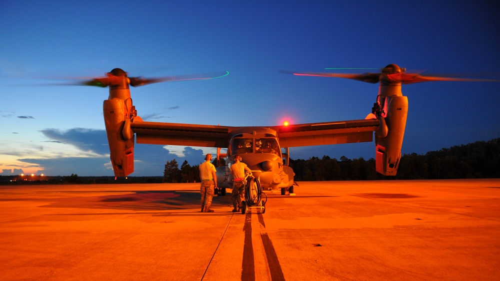 Crew chiefs guide in a CV-22B Osprey