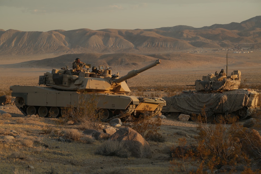 Soldiers maneuver through the terrain