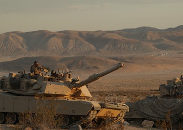 Soldiers maneuver through the terrain