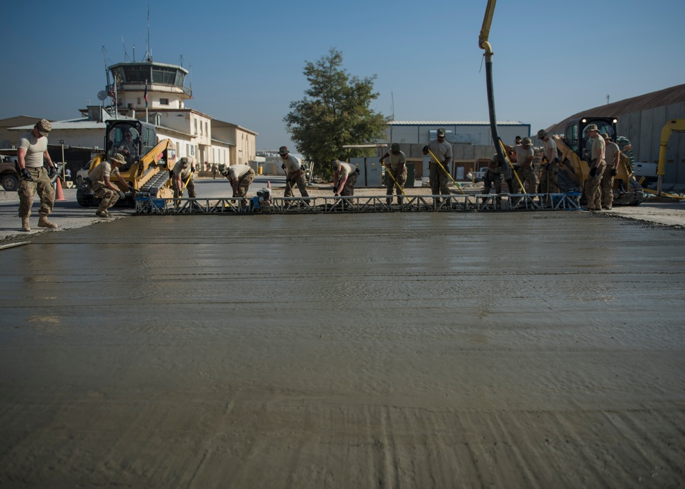 guides a forklift driver during construction, Bagram Airfield, Afghanistan, Sept. 19, 2016. The ECES “dirtboys” placed concrete down in order to extend a parking lot