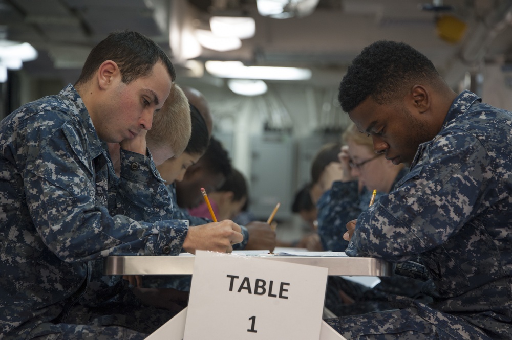 USS America (LHA 6) Saliors take the E-4 Advancement Exam