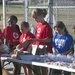 Combat Center youth volunteer in Red Cross bake sale