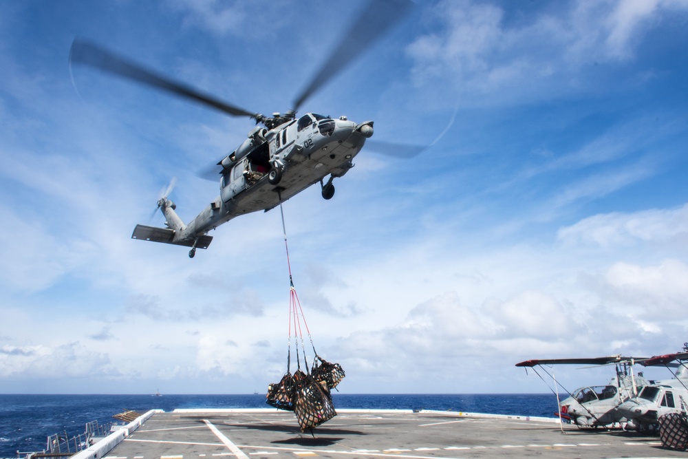 An MH-60S Sea Hawk helicopter conducts a vertical replenishment with USS Green Bay (LPD 20) during Exercise Valiant Shield 2016