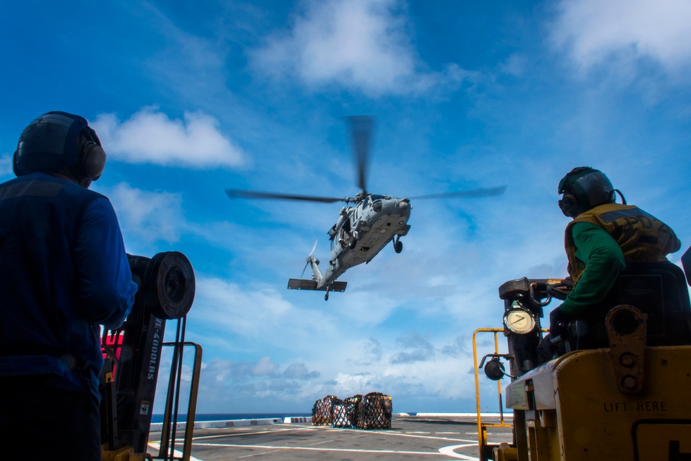 An MH-60S Sea Hawk helicopter conducts a vertical replenishment with USS Green Bay (LPD 20) during Exercise Valiant Shield 2016