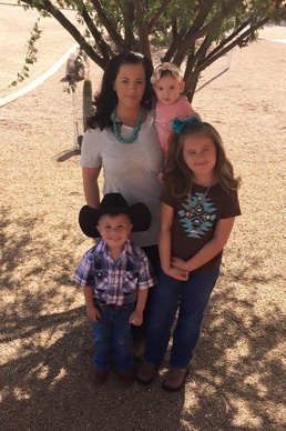 Leslie Beberniss, the wife of Staff Sgt. Nicholas Beberniss, and their children, pose for a photo during a family event.