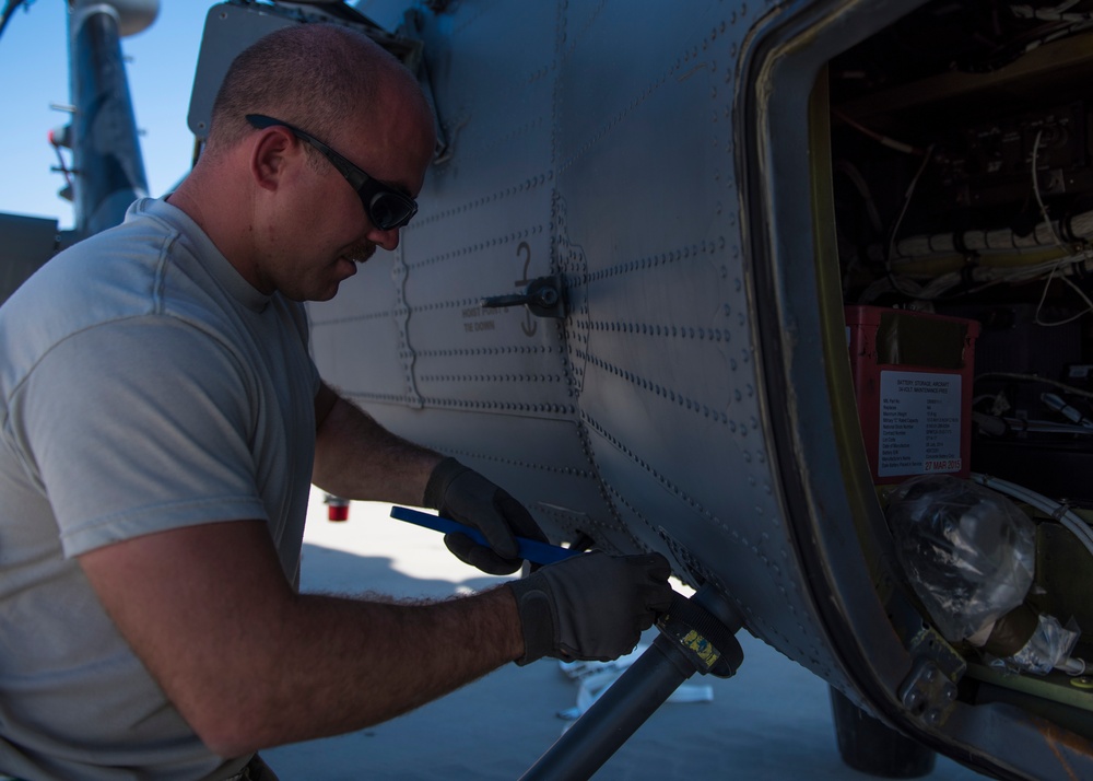 Maintainers unfold an HH-60