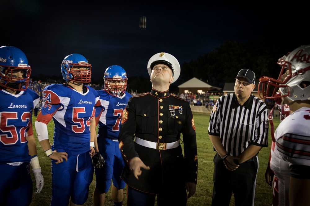 Marine tosses starting coin for Londonderry vs. Pinkerton rivarly game