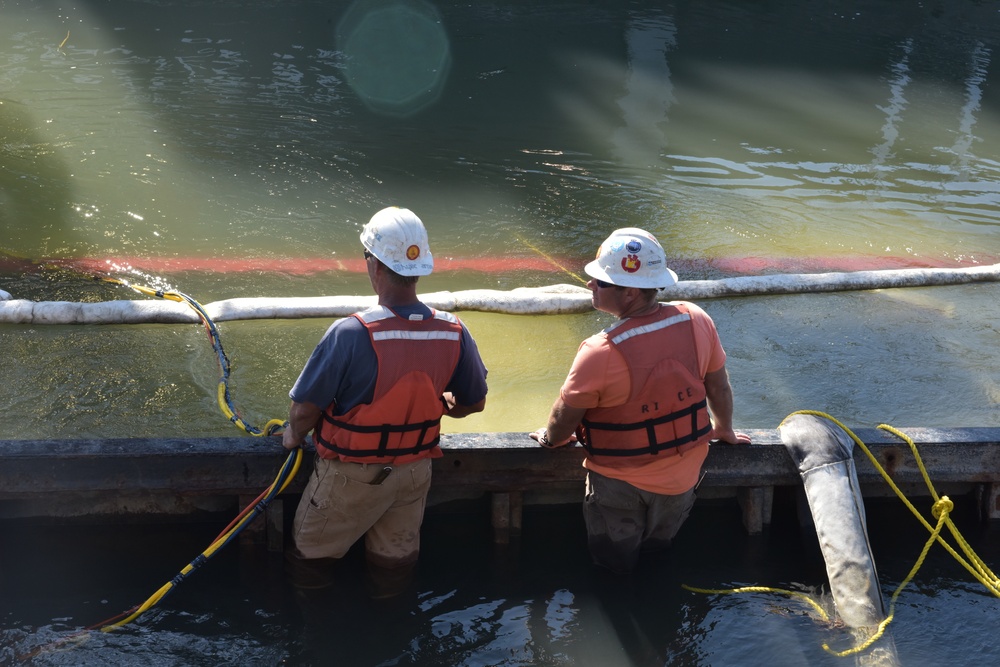 Two Global Diving and Salvage, Inc. personnel wade in the water on top of the sunken Spirit of Sacramento