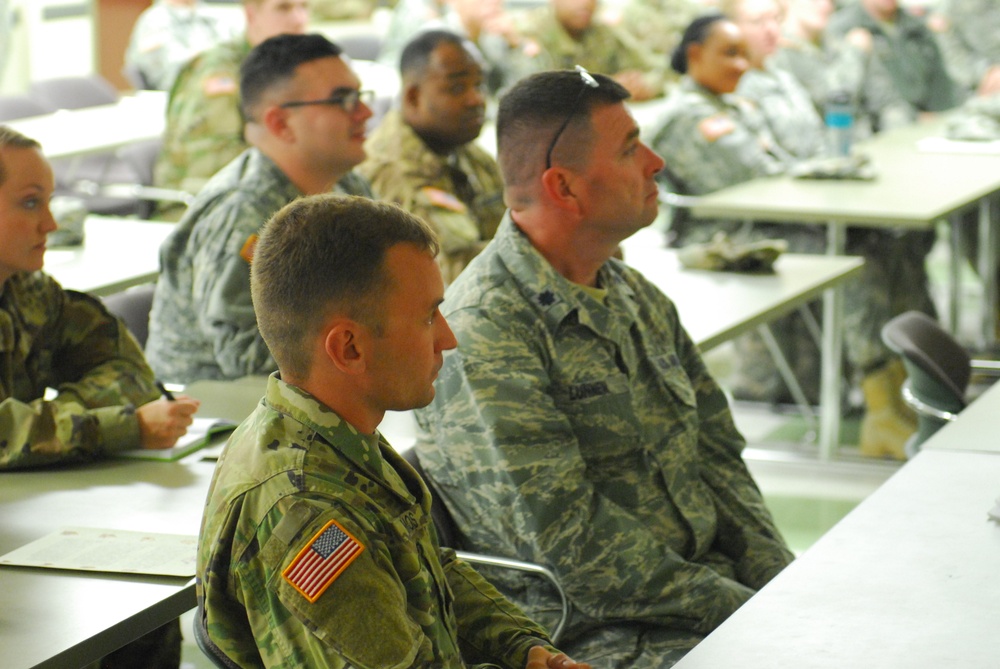 Soldiers and Airmen listen to Army Reserve Command Sgt. Maj. James P. Wills