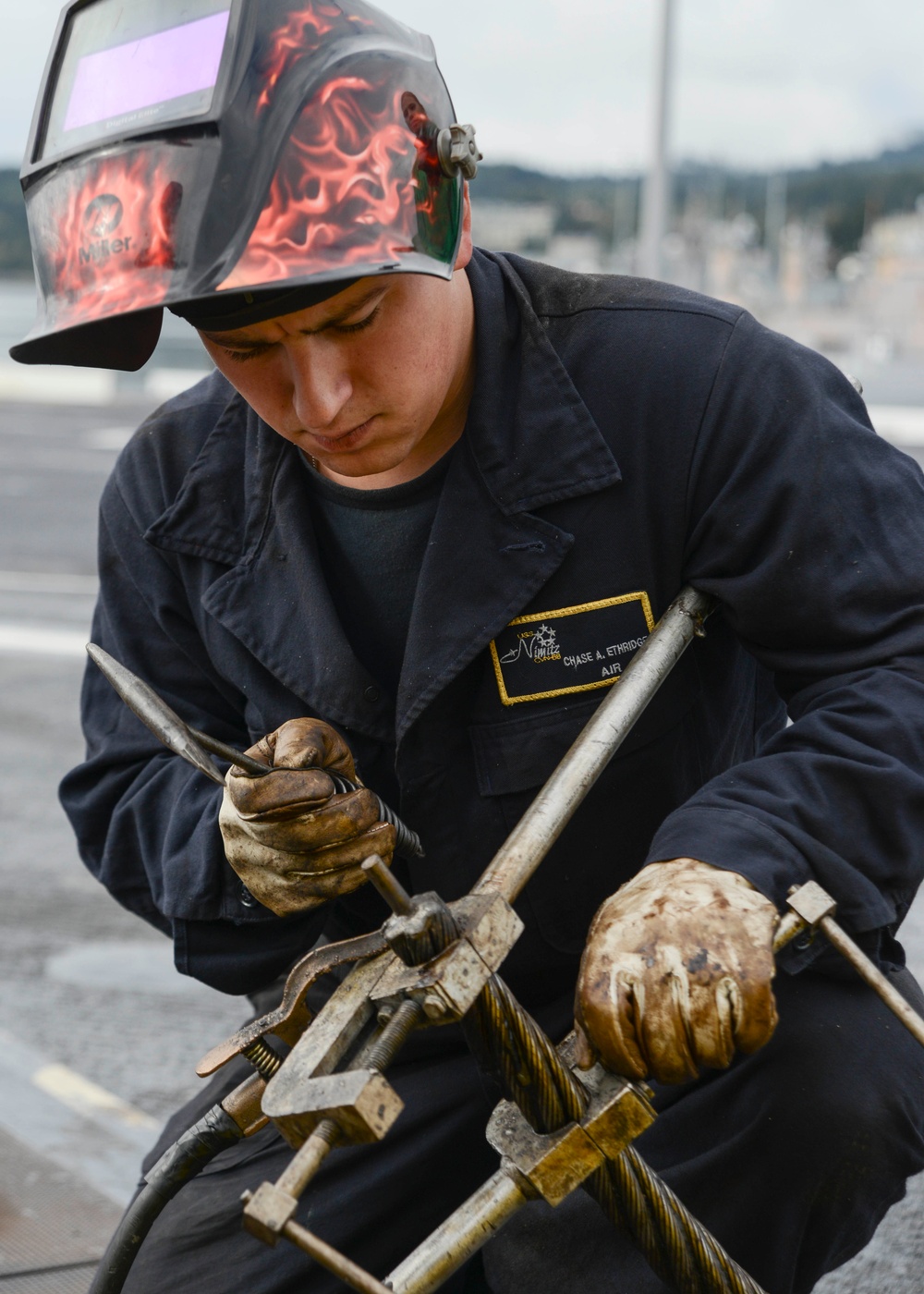 Sailor cleans fresh weld