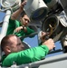 Sailors repair flight deck spotlight