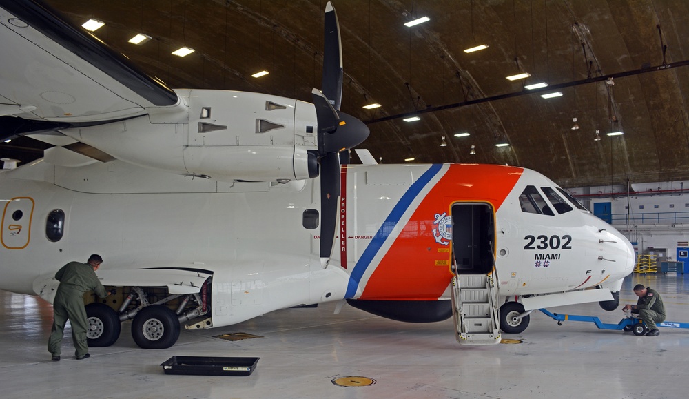 A Coast Guard Air Station Miami HC-144 Ocean Sentry airplane crew prepares the plane for the first post-storm damage assessment flight over Haiti following Hurricane Matthew on October 5, 2016.