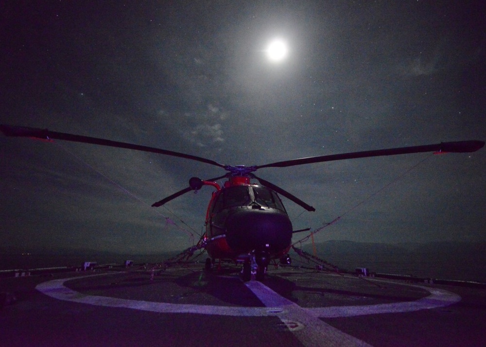 A Coast Guard Air Station Borinquen MH-65 Dolphin helicopter is tied down on the deck of the Coast Guard Cutter Spencer in support of Hurricane Matthew relief efforts in the Caribbean.