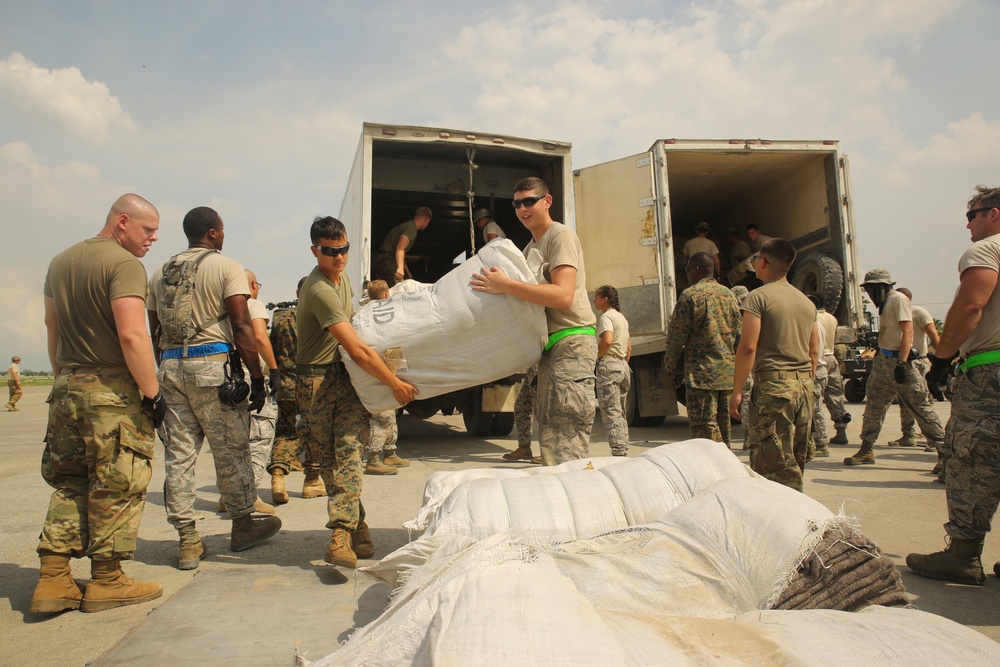 U.S. service members transport supplies to assist Hurricane Matthew victims