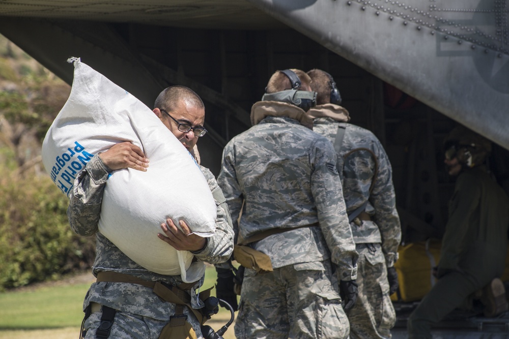 U.S. service members with Joint Task Force Matthew deliver food to Les Anglais, Haiti