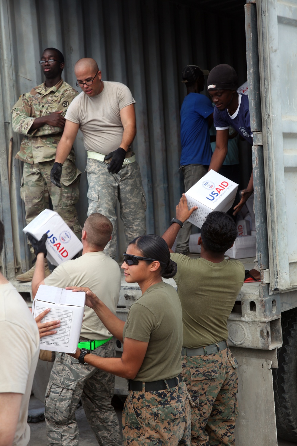 24th MEU radio operator check comms while delivering relief supplies with JTF Matthew