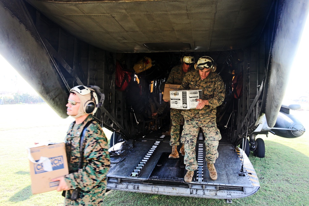 24th MEU radio operator check comms while delivering relief supplies with JTF Matthew