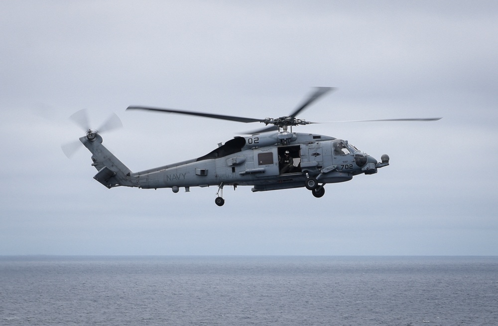 An MH-60R Sea Hawk Flies Above the Horizon