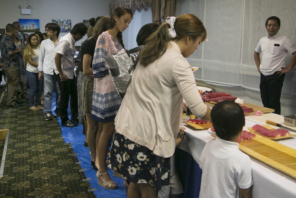 Marines on MCAS Futenma, Ginoza residents participate in tuna cutting party