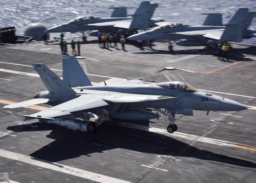An F/A - 18E lands on board USS Nimitz