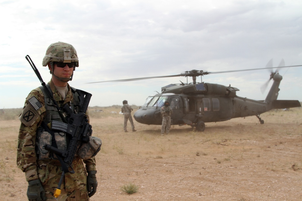 Pilot escorts multinational forces during Army Warfighting Assessment