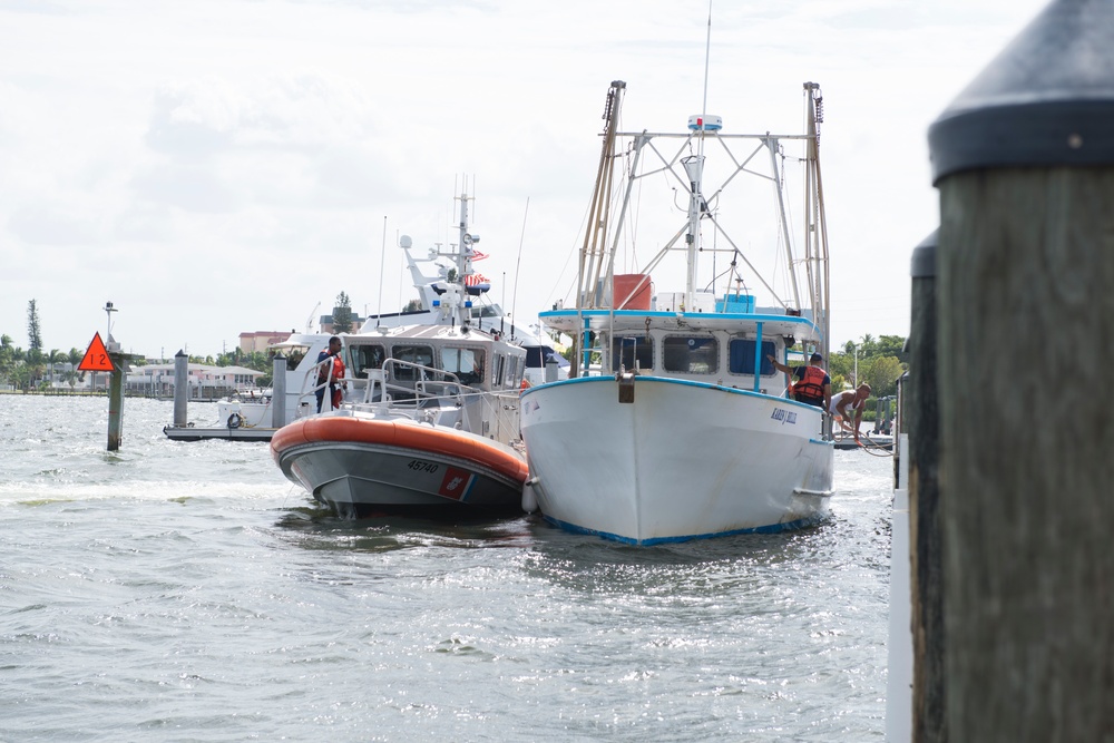 Coast Guard rescues 3, tows disabled boat for 12 hours