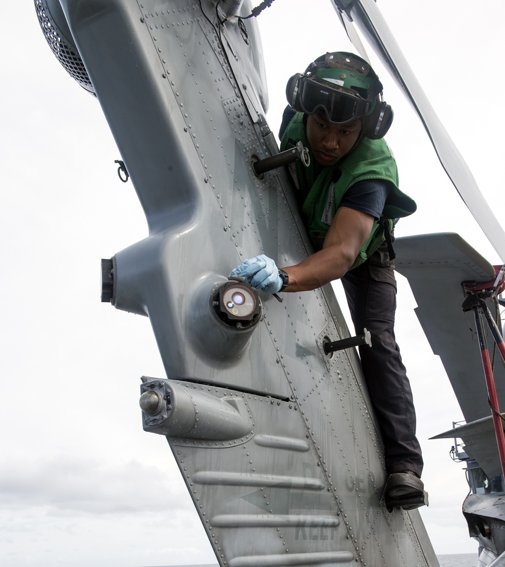 Helicopter Maritime Stirke Squadon (HSM) 78 Sailor Cleans MH-60R Helo