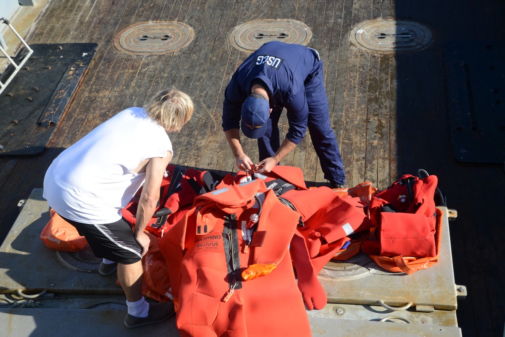 A MST inspects a survival suit on a crabbing vessel