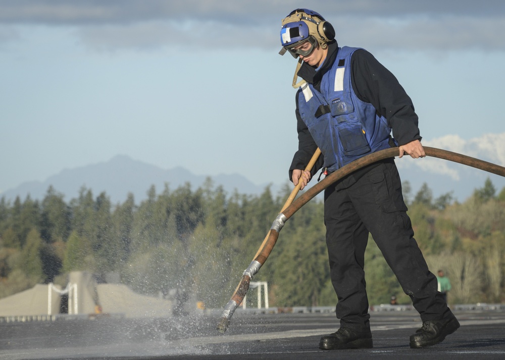 Airman cleans out padeyes