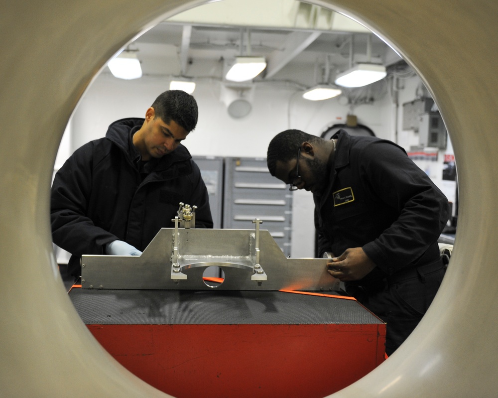 Sailors perform maintenance