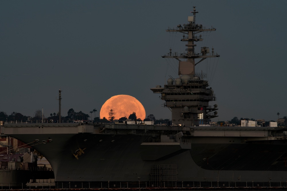 Supermoon sets behind USS Theodore Roosevelt (CVN 71)