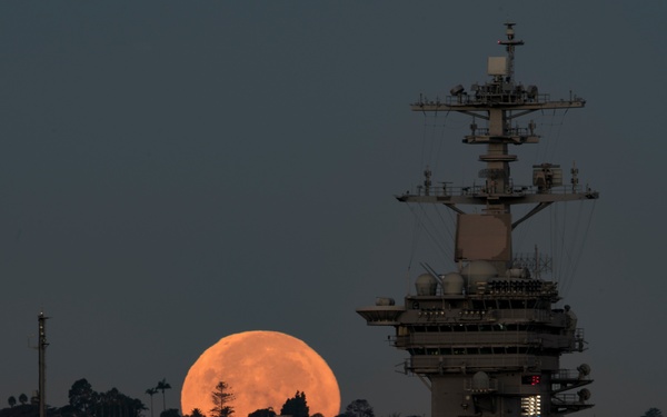 Supermoon sets behind USS Theodore Roosevelt (CVN 71)