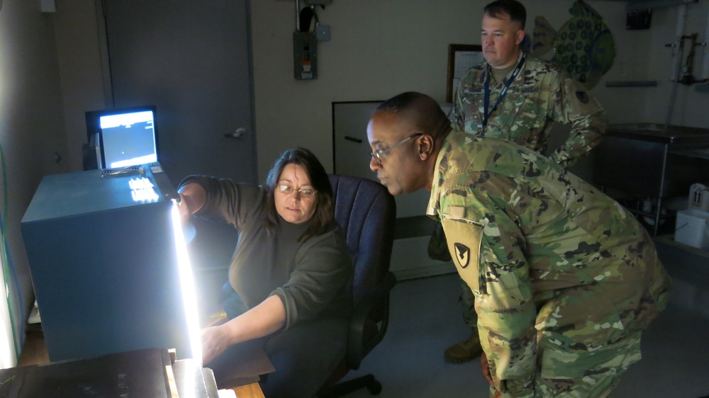 Letterkenny Munitions Center employee, Ms. Lisa Michael, demonstrates X-Ray capabilities to Brig. Gen. Richard Dix, Commanding General of Joint Munitions Command during his visit.