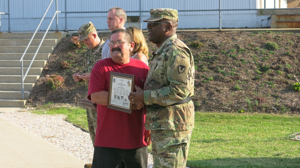 Brig. Gen. Richard Dix, Commanding General of Joint Munitions Command presents Letterkenny Munitions Center employee, Mr. David Grissinger, with a plaque during a ceremony to recognize and thank Vietnam Era Veterans.