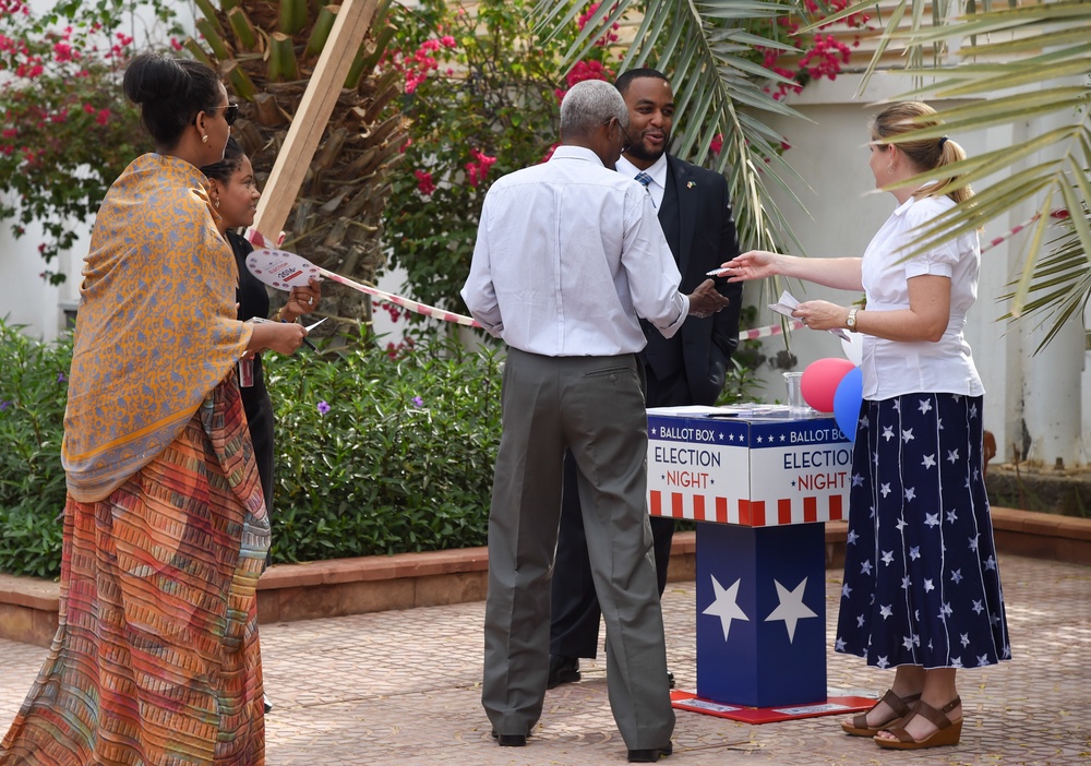 Guests of the U.S. Ambassador to Djibouti gather at his home during an Election Day breakfast