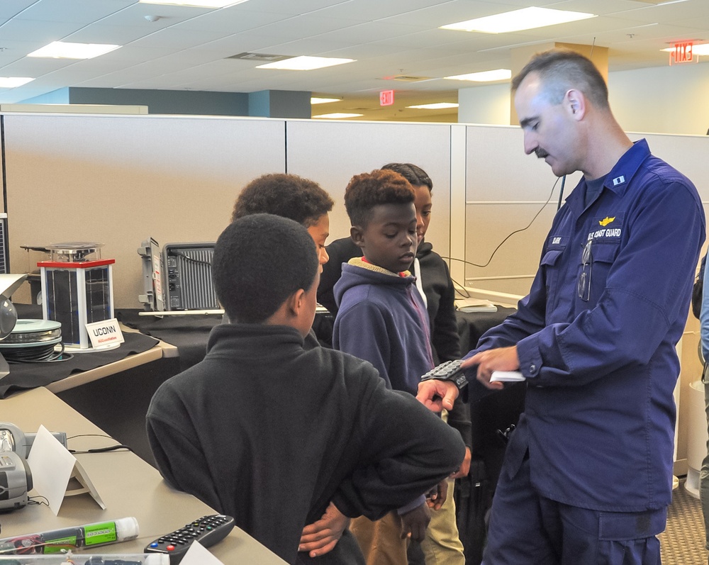 LT Charles Clark demonstrates a prototype for a personally-worn hazardous atmosphere detection kit developed at the Coast Guard Research and Development Center