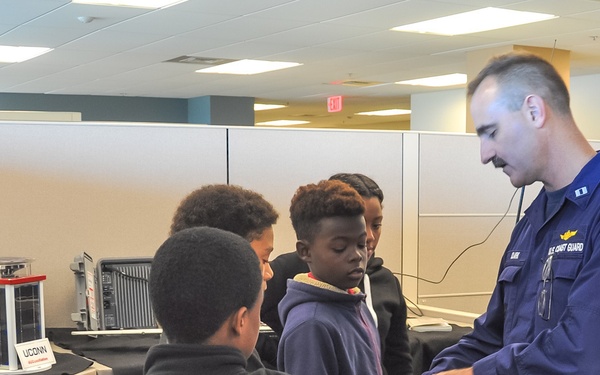 LT Charles Clark demonstrates a prototype for a personally-worn hazardous atmosphere detection kit developed at the Coast Guard Research and Development Center