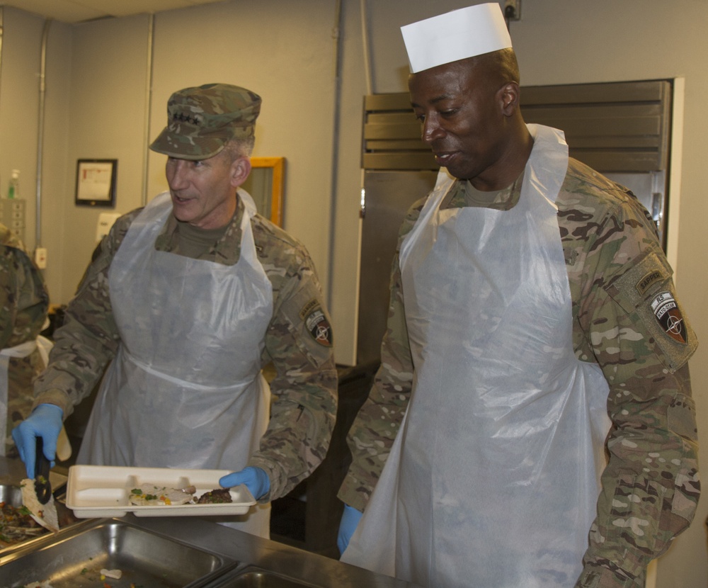 Gen. John Nicholson and Command Sgt. Maj. David M. Clark serve Thanksgiving lunch