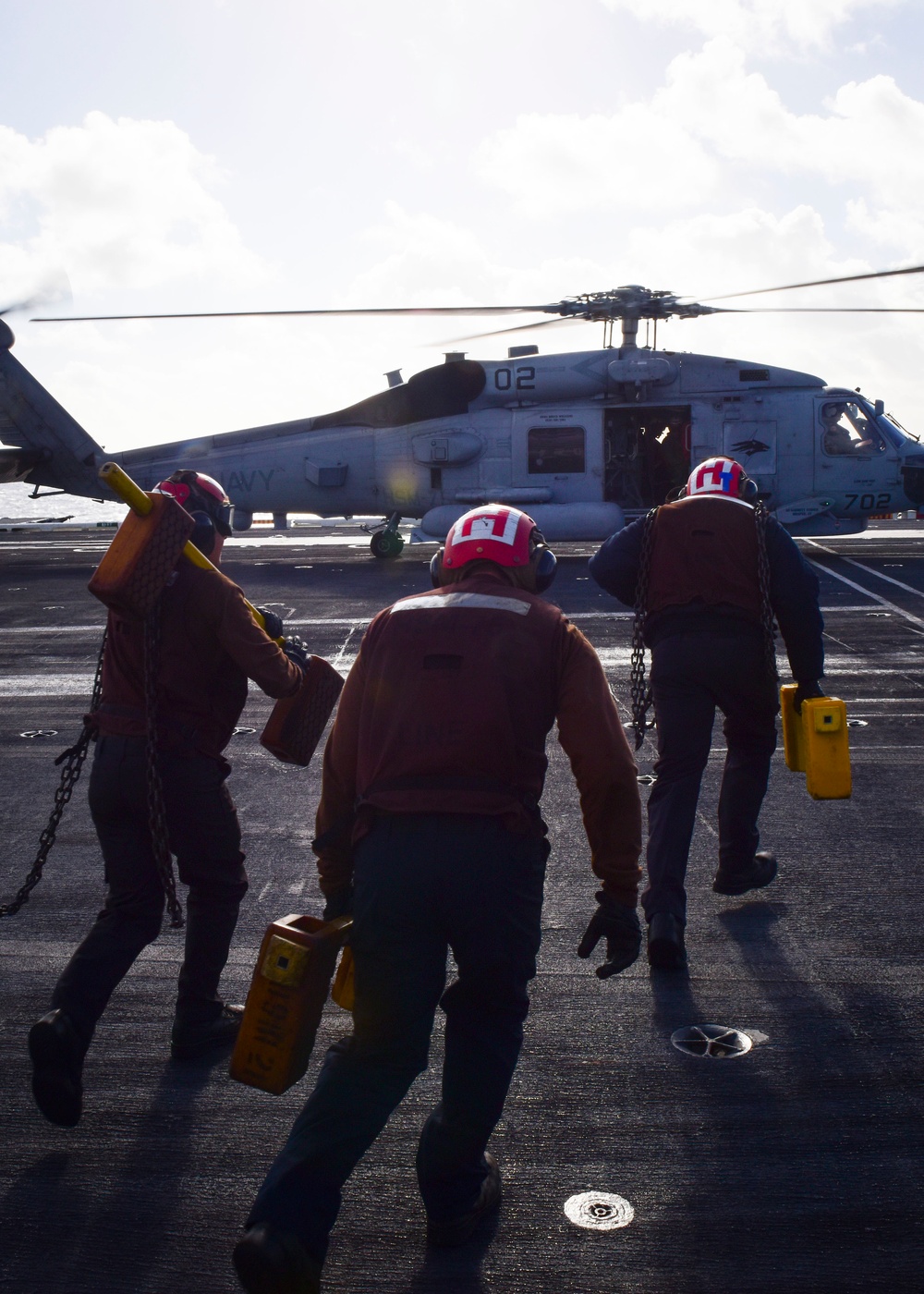 Sailors chock and chain MH-60S helicopter
