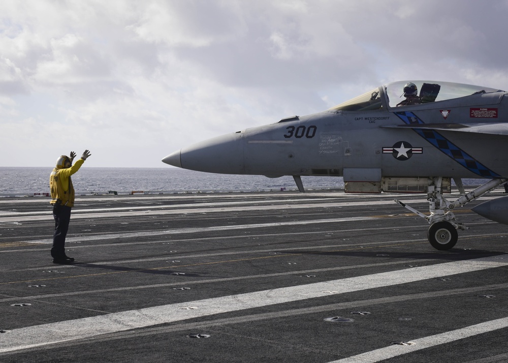 Sailor directs an F/A-18C on Nimitz's flight deck