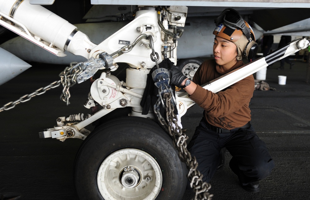Sailor cleans flight equipment