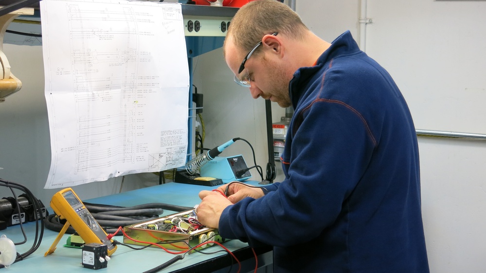 Letterkenny Munitions Center Electronic Measurement Equipment Mechanic, Chad Reams, tests a power switching module from a piece of MFOM test equipment.