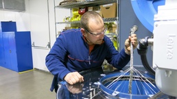 Letterkenny Munitions Center Electronic Measurement Equipment Mechanic, Chad Reams, uses the braiding machine to put the final layer of shielding on a cable assembly.