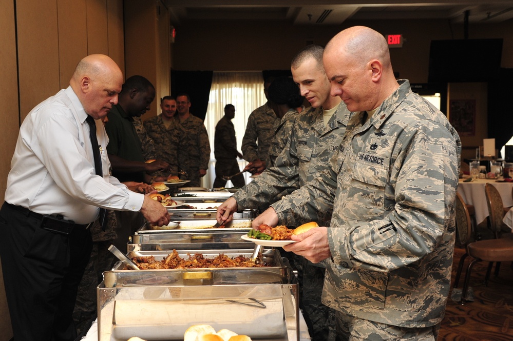 Airmen prepare to eat at luncheon