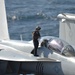 Sailor conducts maintenance on Growler
