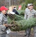 Airmen turn farm hand to help service member’s holidays