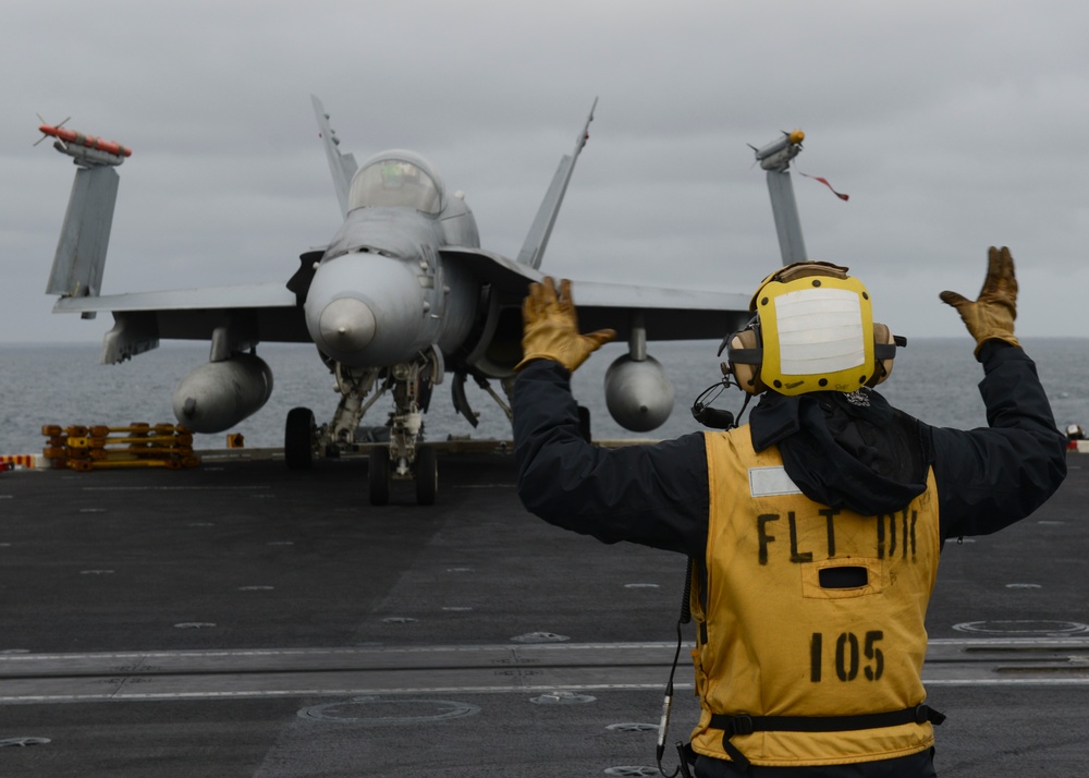 Sailor conducts preflight check with an F/A-18C