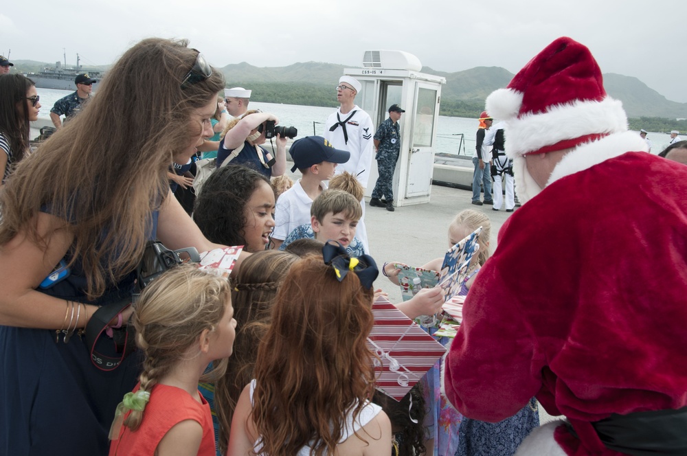&quot;Santa&quot; Hands out Gifts during the USS Oklahoma City (SSN 723) Return to Guam Dec. 8, 2016