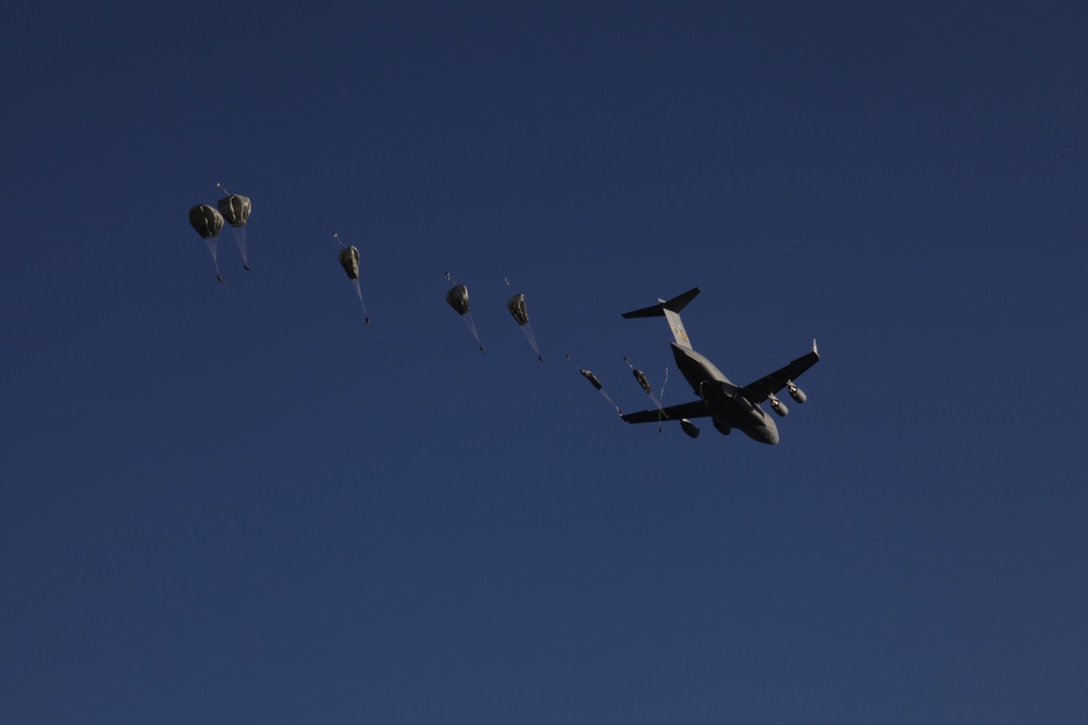 Paratroopers descending from aircraft